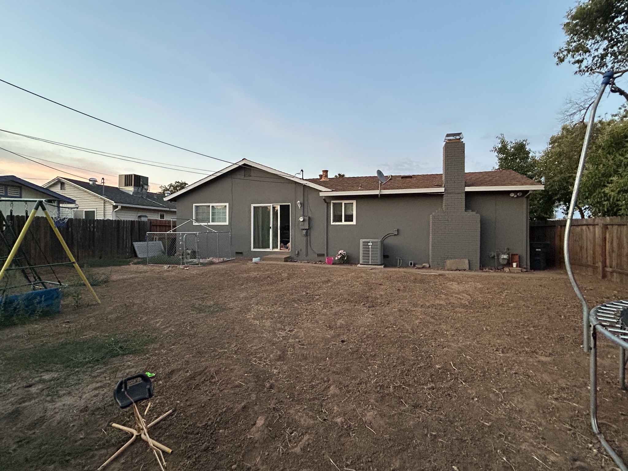Perfect example of yard photo - backyard with dirt area ready for landscaping, taken from ideal angle